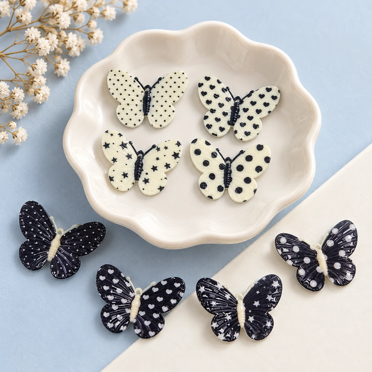 Black and White Spotted Butterfly Resin Charms RW002637 displayed for assortment selection