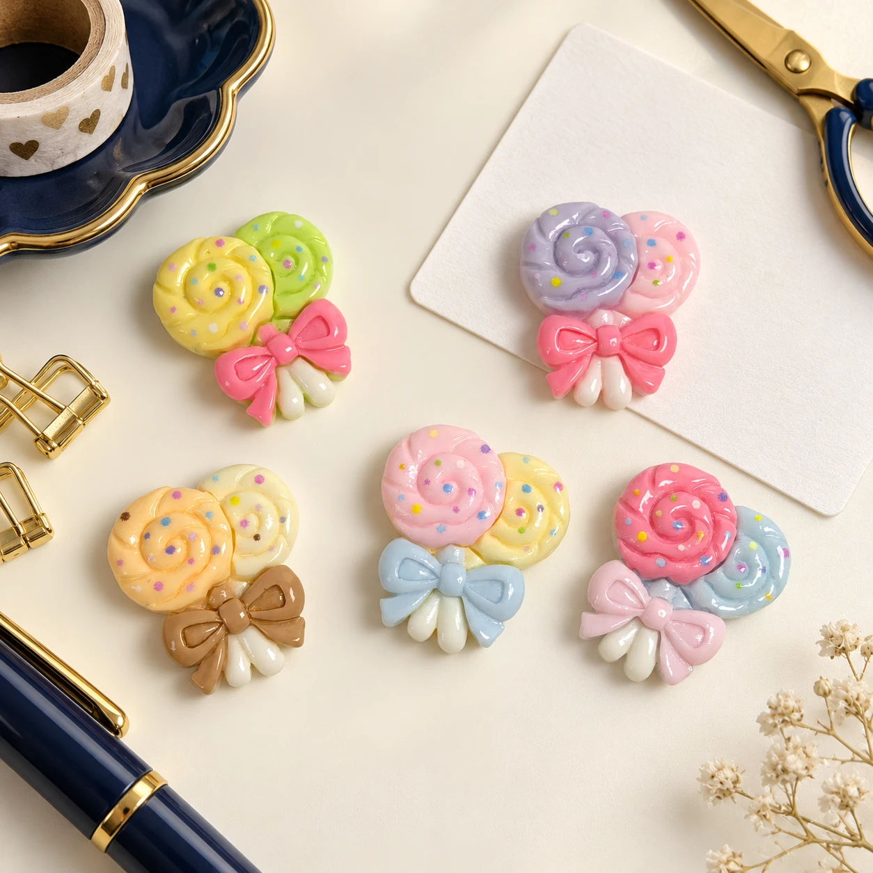 Bow Lollipop Resin Charms RW003564 in an illustrative craft workspace