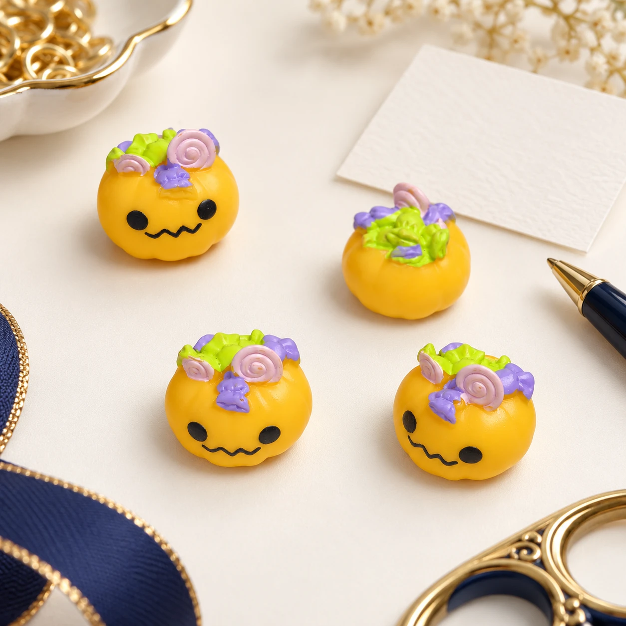 Halloween Candy Pumpkin Resin Charms RW001917 in an illustrative craft workspace