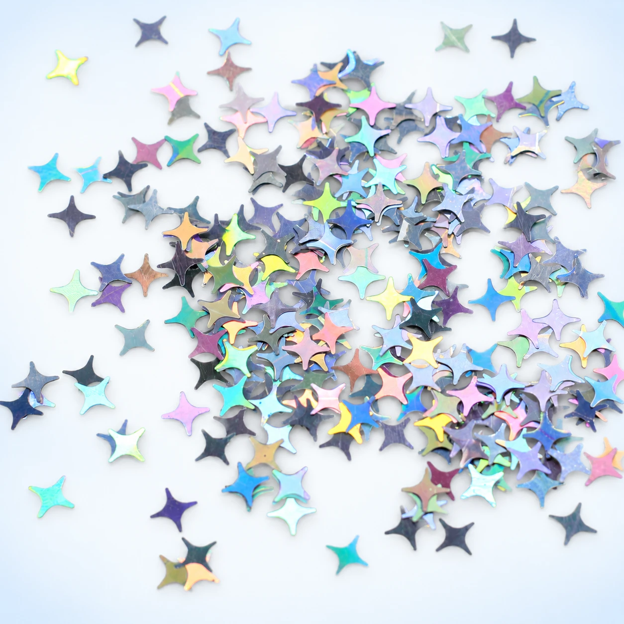 Iridescent Four-Point Star Sequins MA033 on a clean light studio background