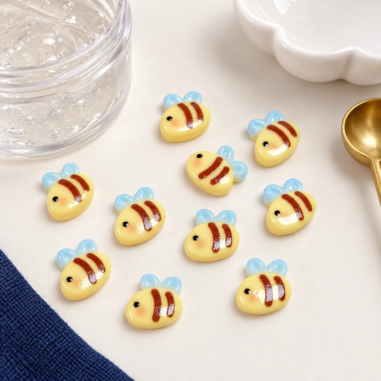 Mini Bee Resin Flatback Cabochons RW002498 in an illustrative craft workspace