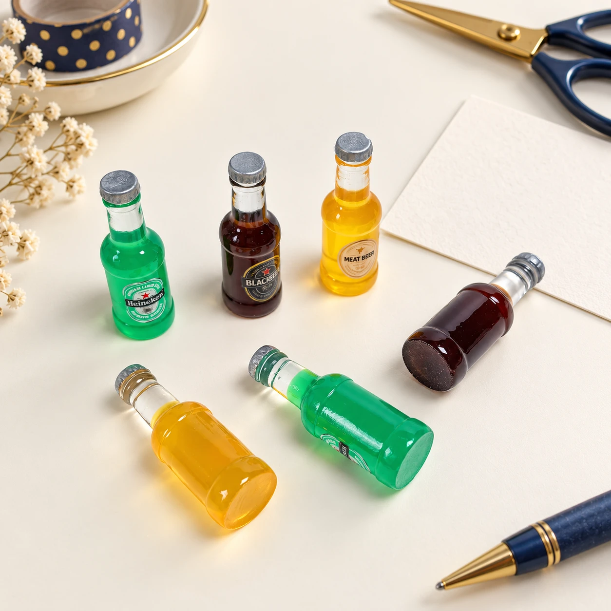 Mini Beer Bottle Resin Charms RW002656 in an illustrative craft workspace