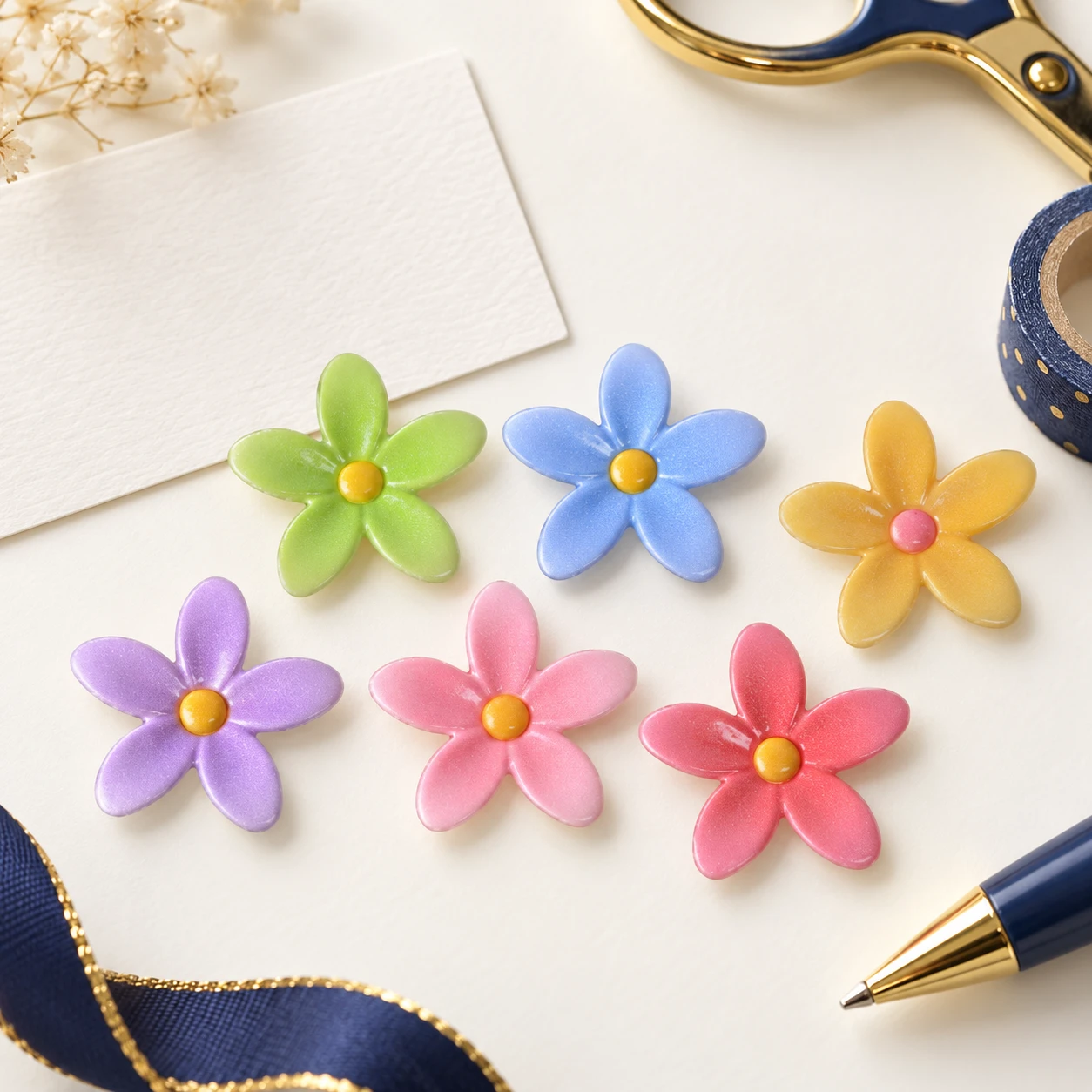 Pastel Five-Petal Flower Resin Charms RW00575 in an illustrative craft workspace