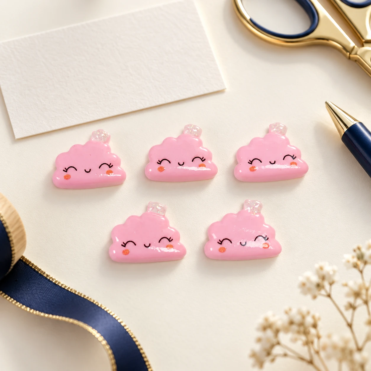 Pink Smiling Cloud Resin Charms RW001862 in an illustrative craft workspace