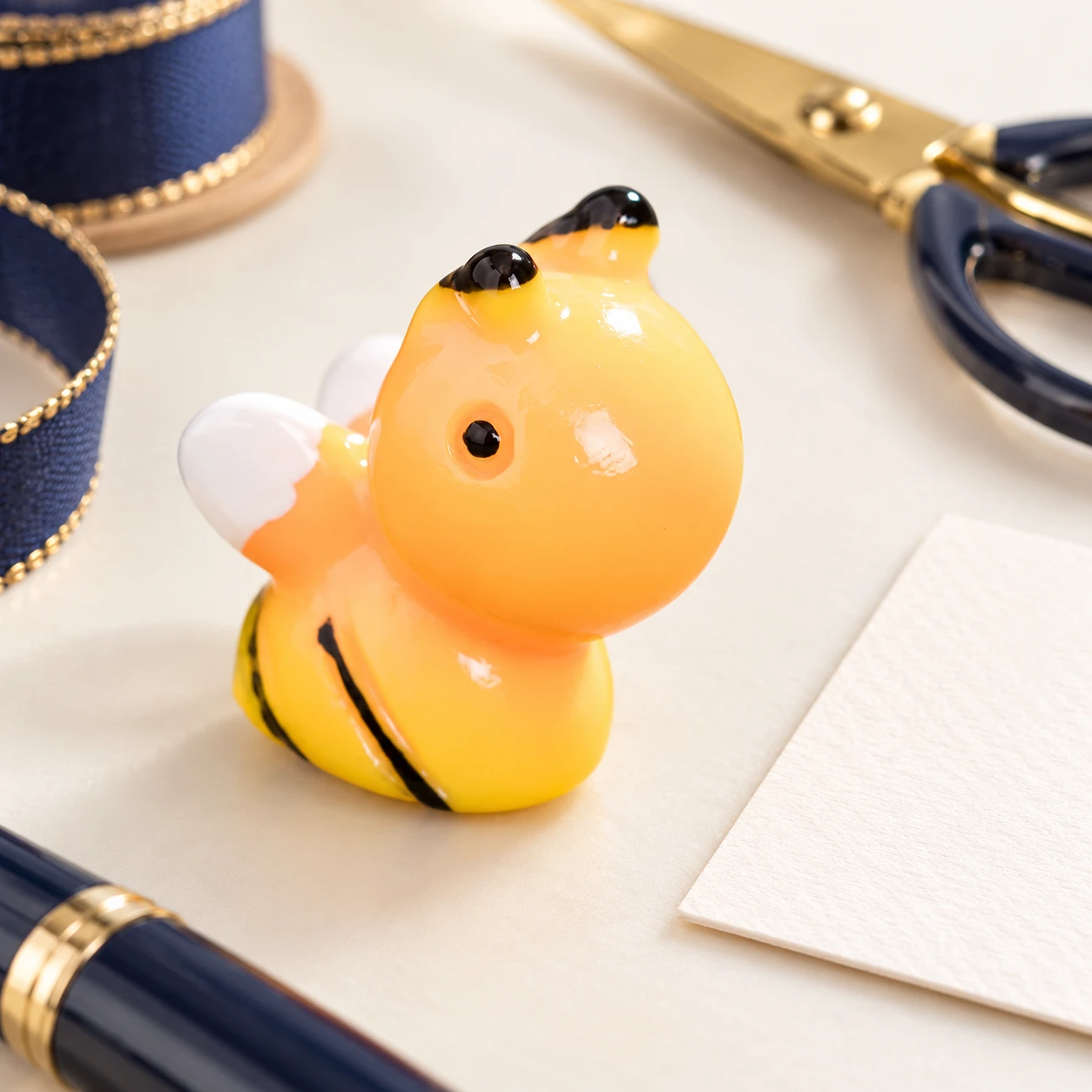 Rounded Bee Resin Charm RW002203 in an illustrative craft workspace