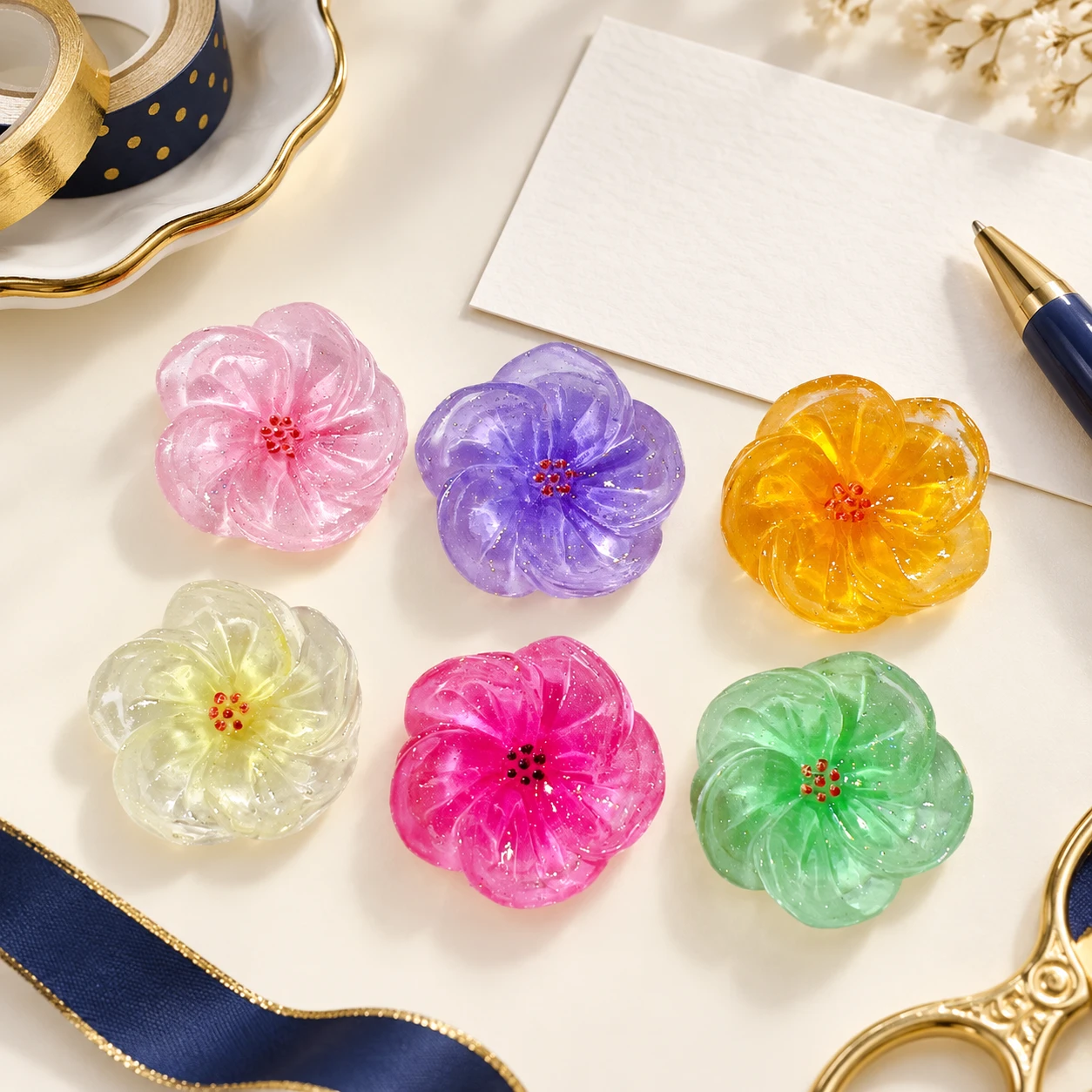 Translucent Glitter Flower Resin Charms RW0022500 in an illustrative craft workspace