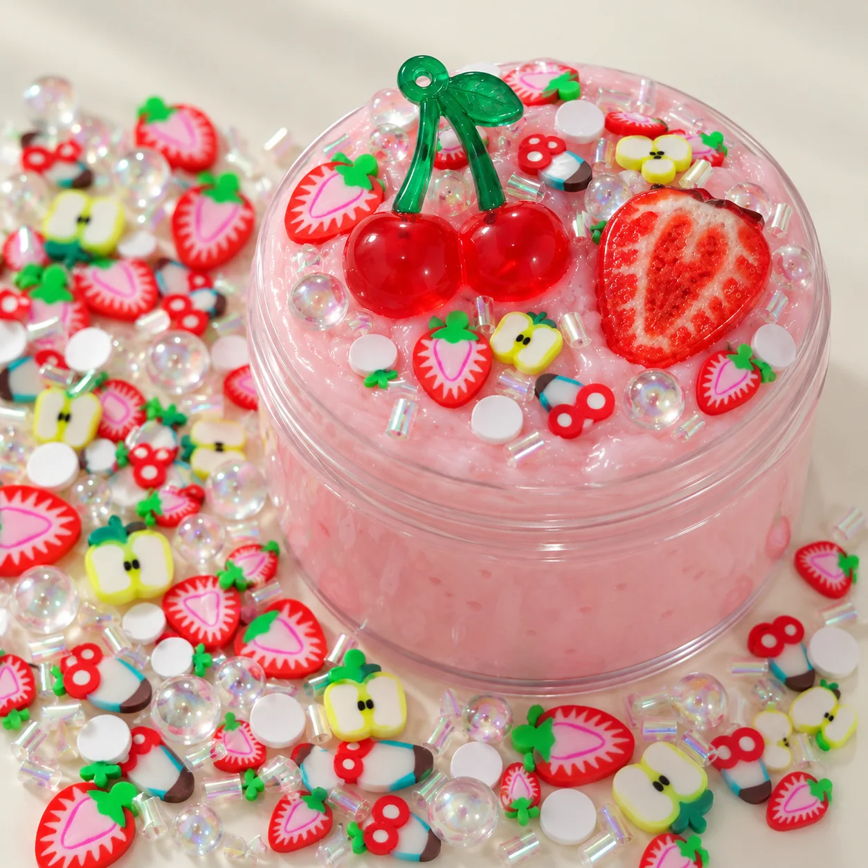 Illustrative pink slime jar topped with cherry and strawberry craft filler pieces