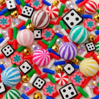 Close view of striped candy, dice and peppermint patterned filler pieces
