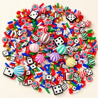 Studio overview of striped candy charms with dice, peppermint motifs and faceted accents