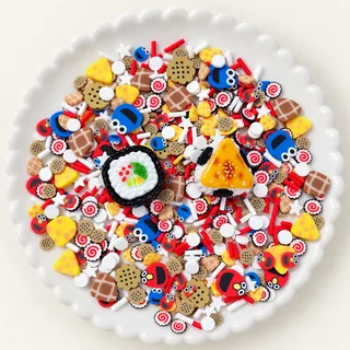 Studio overview of round and triangular focal charms with cookie, waffle, spiral and face motifs