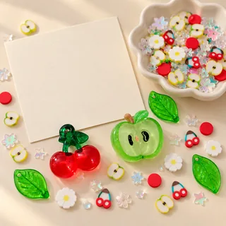 Illustrative blank craft card beside loose cherry, apple, leaf and daisy filler pieces