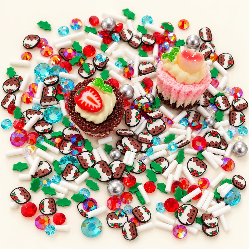 Studio overview of strawberry tart and pink cupcake charms with pudding slices, holly shapes and colored accents