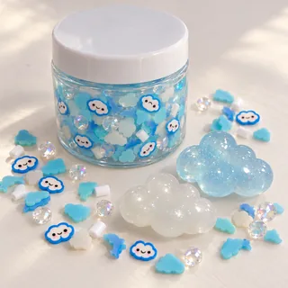 Illustrative slime sample jar near loose blue and white cloud charms and smiling cloud pieces