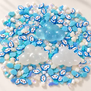 Studio overview of three large blue and white cloud charms with smiling blue-outlined cloud slices and clear beads