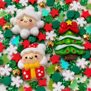 Close detail of green Christmas tree and white holiday focal charms with red stars and snowflake pieces