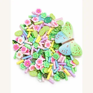 Close view of pastel butterfly focal charm and miniature flower and green slices