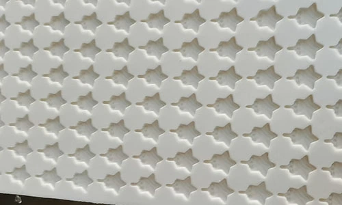 Close view of a white mould containing repeated star-shaped cavities