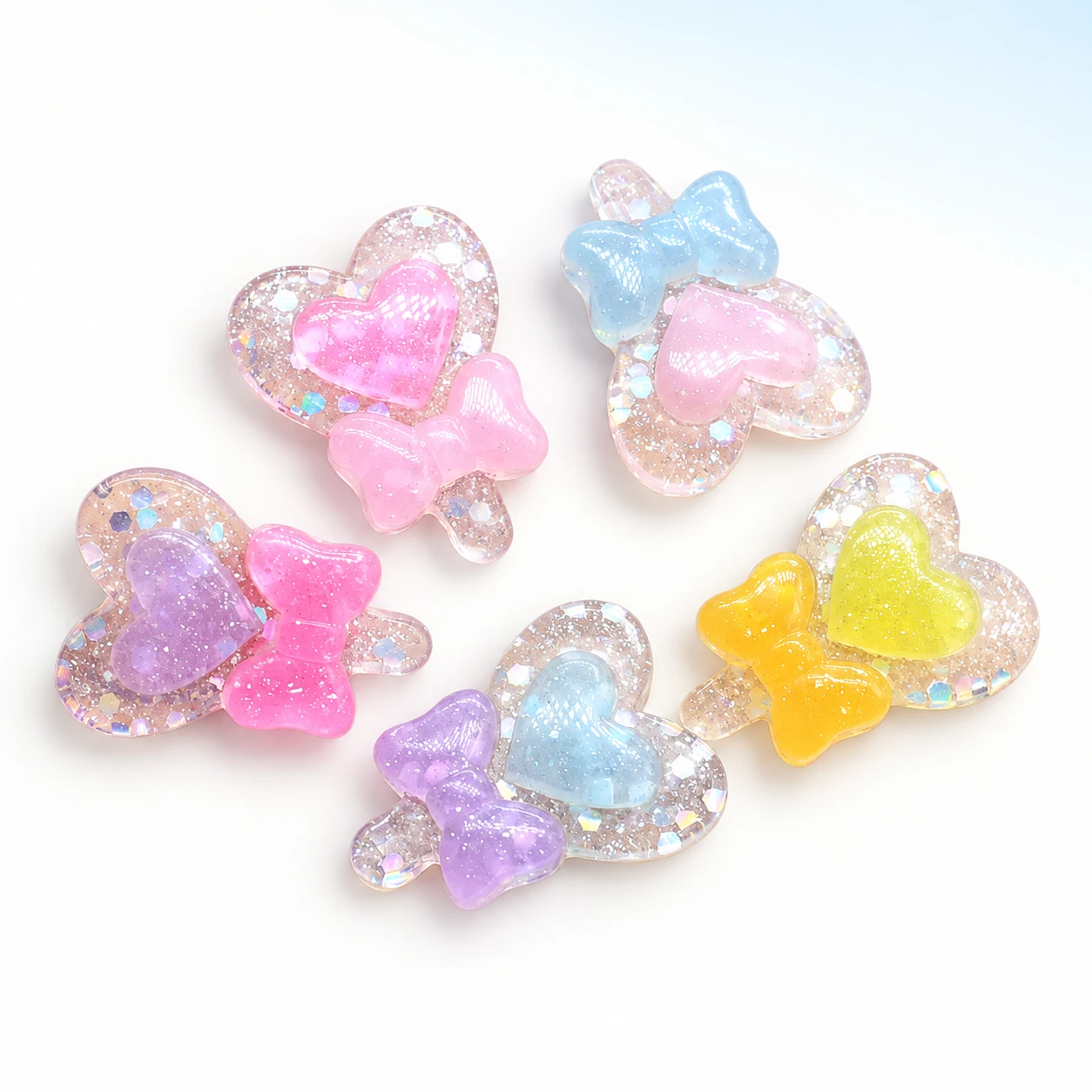 Glitter Heart & Bow Resin Charms on a bright white studio background, RW2041