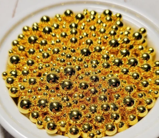 Original photograph of mixed-size metallic gold no-hole faux pearl beads in a white dish